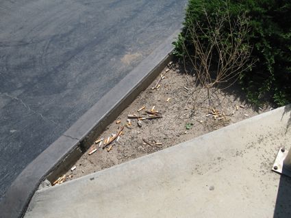 Port Xpresso Cafe - Before: Customer butt litter at entrance